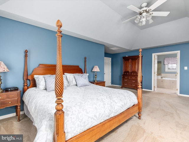 bedroom featuring light carpet, ensuite bath, baseboards, ceiling fan, and vaulted ceiling