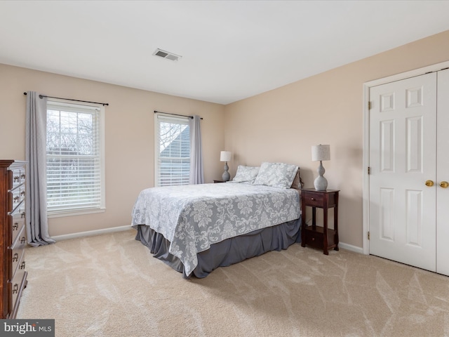 bedroom with carpet flooring, baseboards, and visible vents