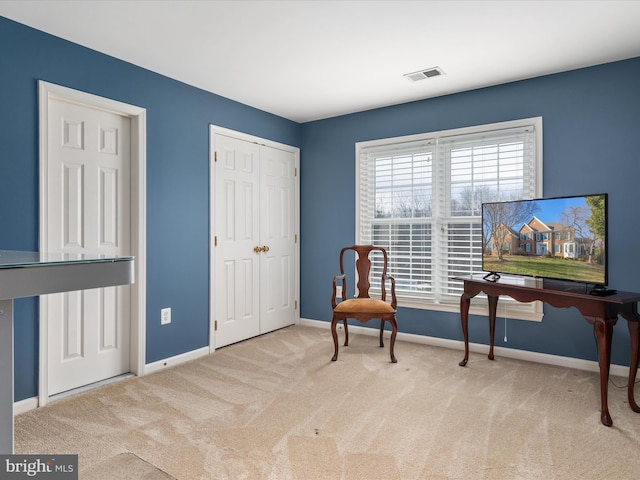 sitting room featuring visible vents, carpet floors, and baseboards