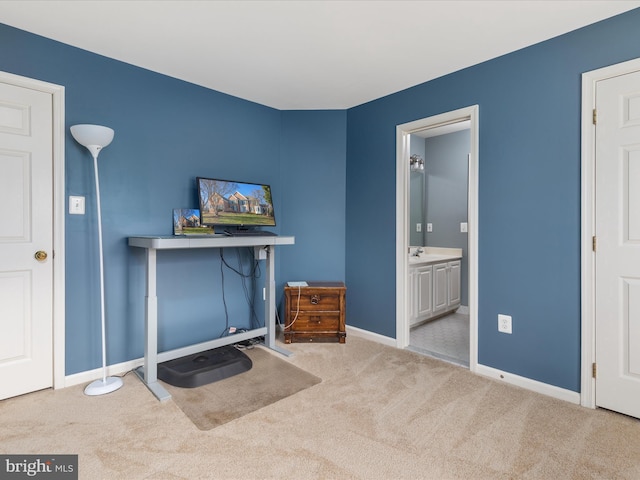 interior space featuring ensuite bathroom and baseboards