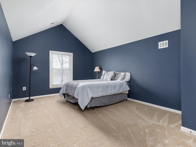 bedroom with visible vents, baseboards, carpet flooring, and vaulted ceiling