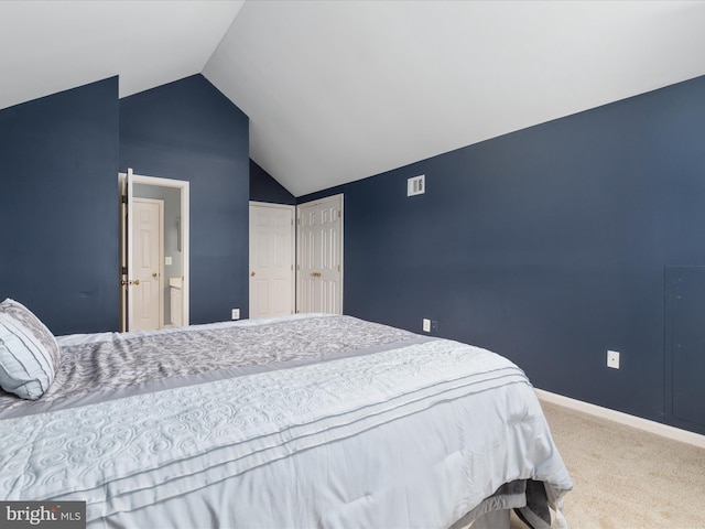 bedroom with visible vents, baseboards, lofted ceiling, and carpet floors