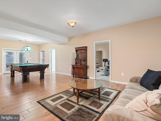 living area featuring baseboards, pool table, and light wood finished floors