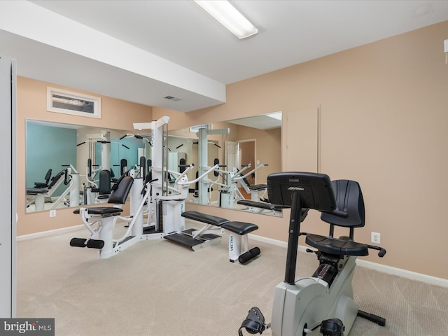 workout area featuring visible vents, baseboards, and carpet floors