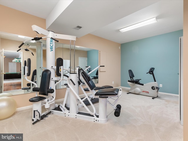 workout area with visible vents, carpet floors, and baseboards