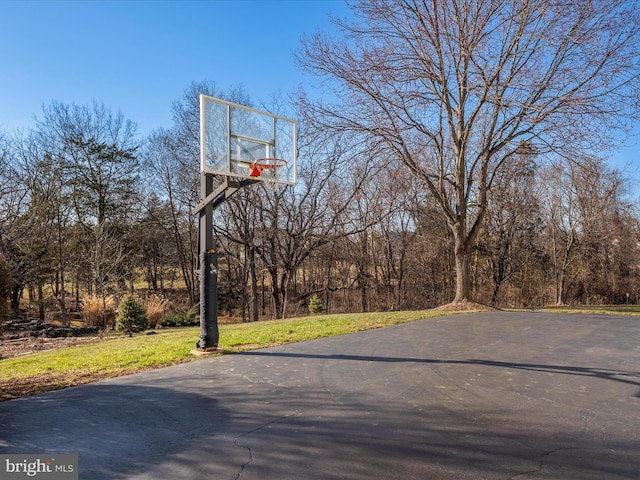 view of sport court featuring a yard and basketball court