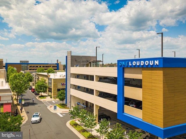 view of building exterior with uncovered parking