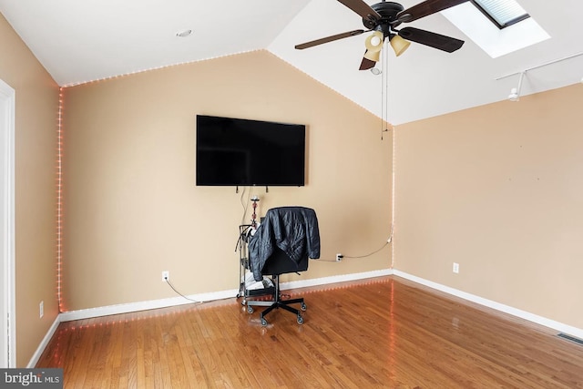 unfurnished office featuring vaulted ceiling, wood-type flooring, and ceiling fan