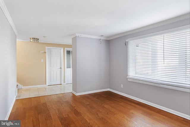 spare room with crown molding and light hardwood / wood-style floors