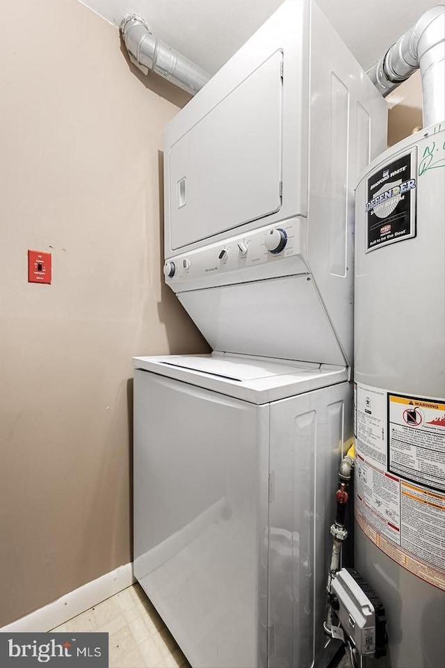 laundry area featuring stacked washer and dryer and water heater