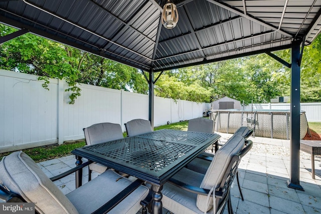 view of patio / terrace with a shed and a gazebo