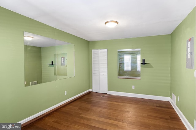 unfurnished bedroom featuring hardwood / wood-style flooring and a closet