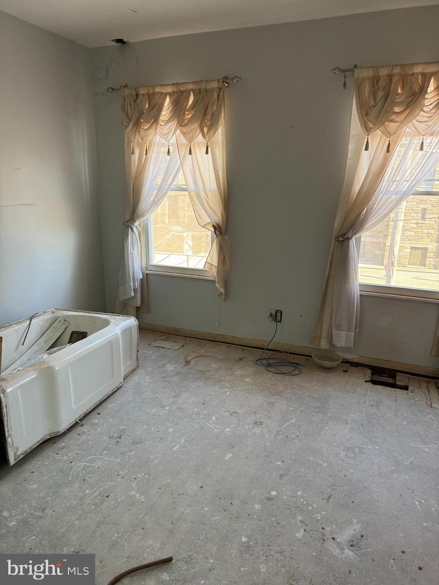 unfurnished bedroom featuring multiple windows