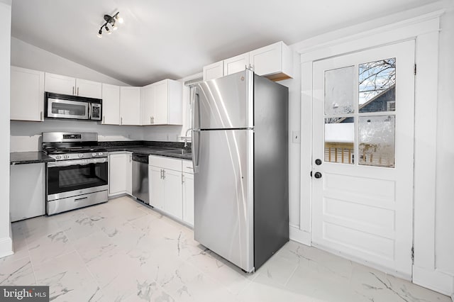 kitchen featuring white cabinetry, sink, vaulted ceiling, and appliances with stainless steel finishes