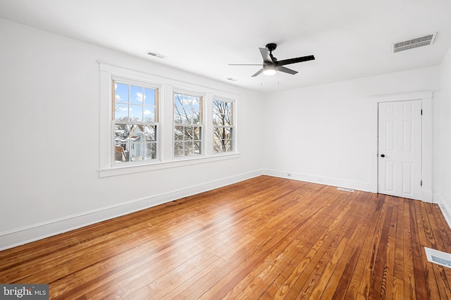 unfurnished room with hardwood / wood-style floors and ceiling fan