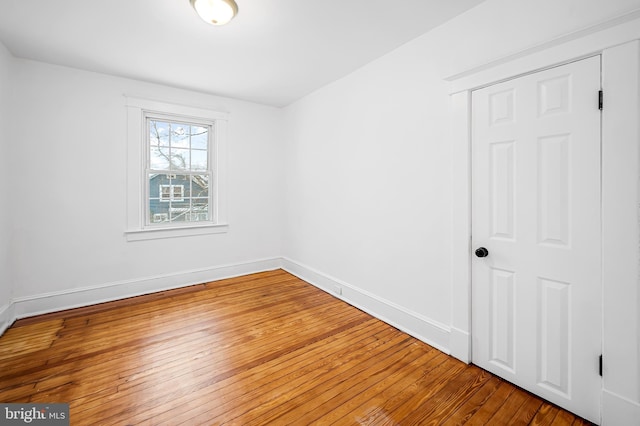 spare room with wood-type flooring