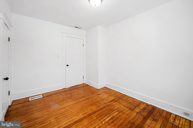 unfurnished room with hardwood / wood-style floors