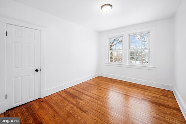 spare room with wood-type flooring