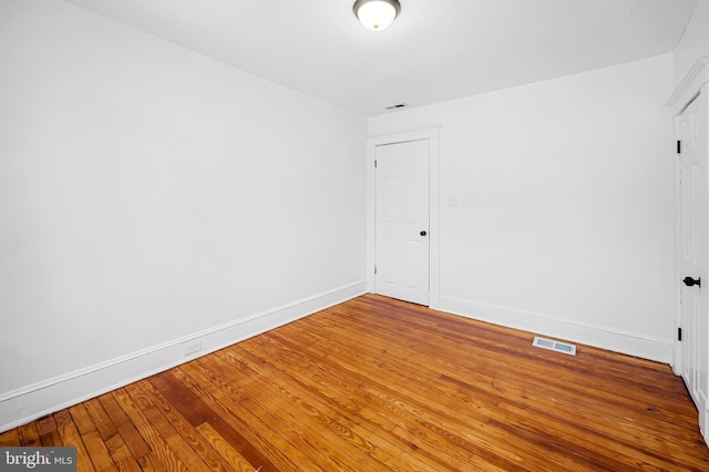 unfurnished room with hardwood / wood-style floors