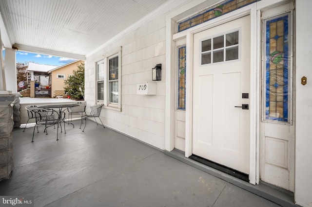 view of exterior entry with covered porch