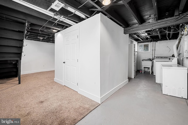 basement featuring washing machine and dryer and sink