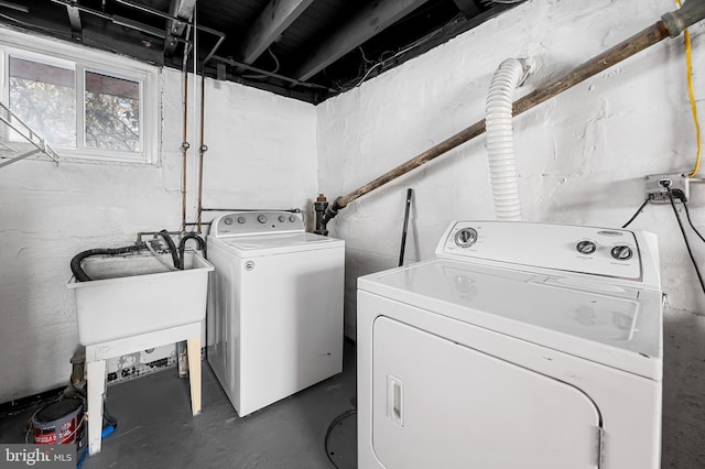 laundry room with separate washer and dryer and sink