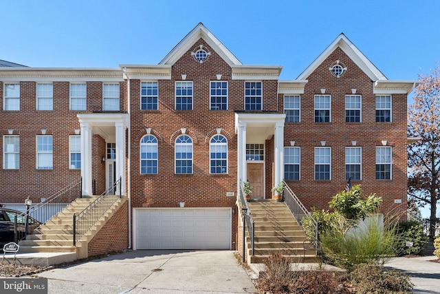 view of front of house with concrete driveway, brick siding, and an attached garage