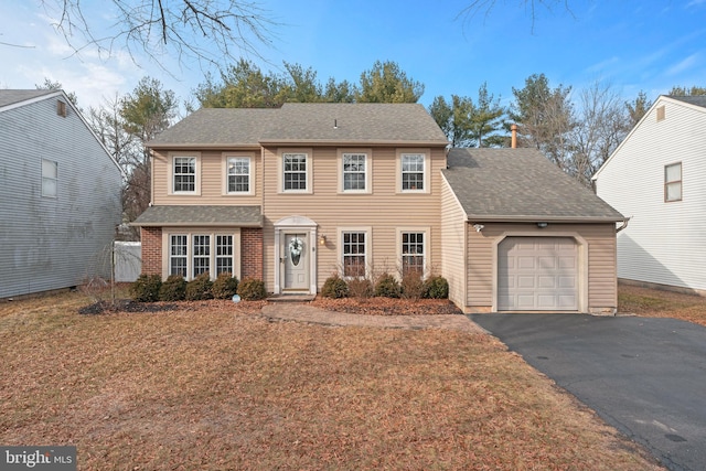 view of front of home with a garage and a front yard