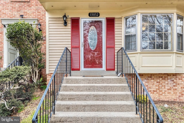 entrance to property with brick siding