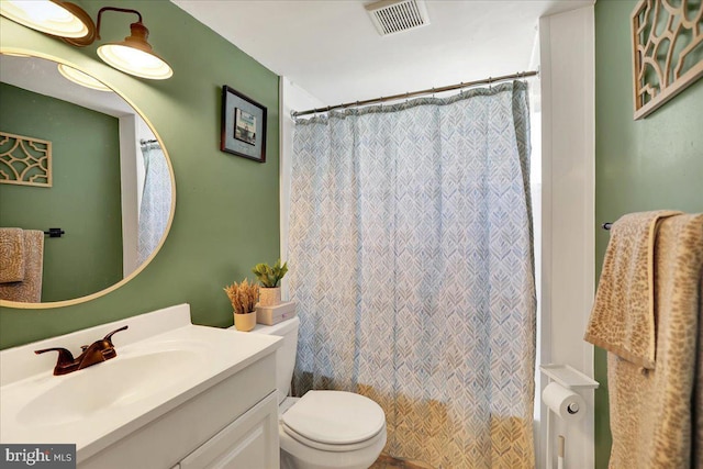 bathroom with radiator heating unit, vanity, toilet, and walk in shower