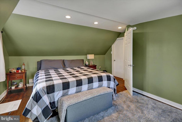 bedroom featuring vaulted ceiling and hardwood / wood-style floors