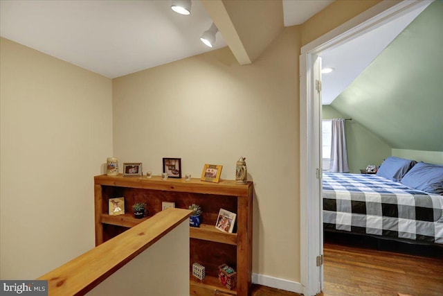 bedroom with vaulted ceiling and wood-type flooring