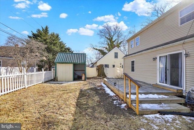 view of yard featuring a storage shed and a wooden deck