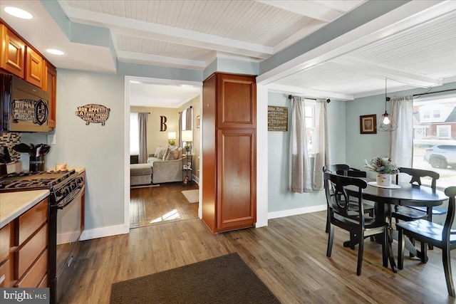 dining space with dark hardwood / wood-style flooring, wood ceiling, and beam ceiling