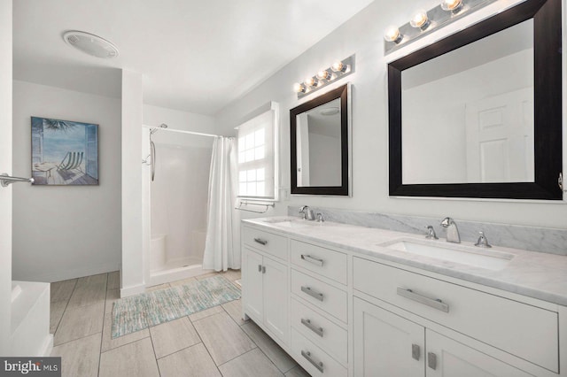 bathroom featuring vanity and curtained shower