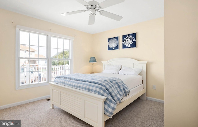 bedroom featuring light colored carpet and ceiling fan