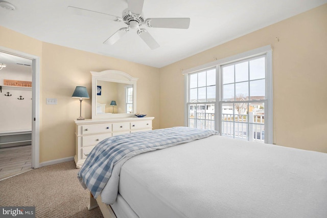 bedroom featuring light carpet and ceiling fan