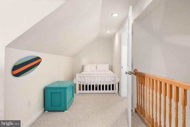 bedroom with vaulted ceiling and light carpet