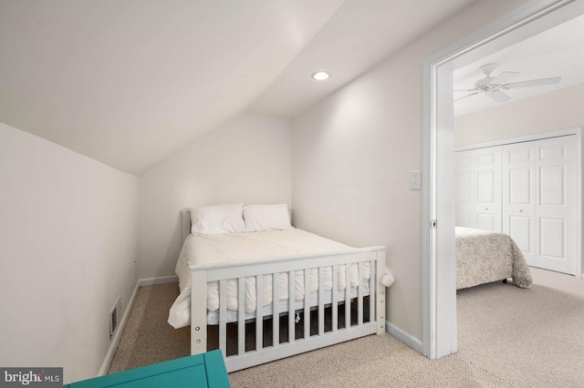 bedroom with lofted ceiling, carpet flooring, and a closet