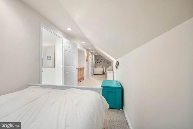 bedroom featuring lofted ceiling and light colored carpet