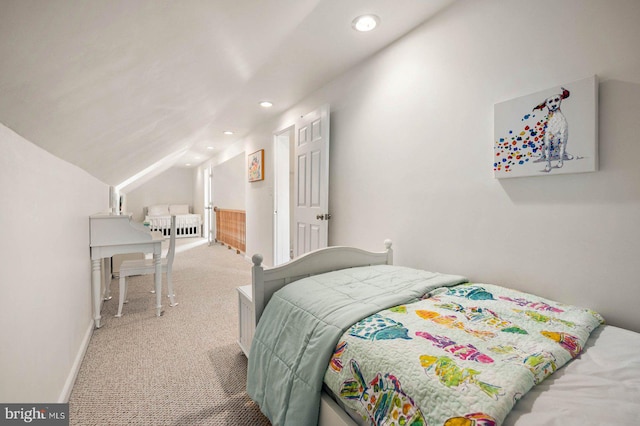 bedroom with lofted ceiling and carpet floors