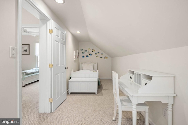 bedroom with vaulted ceiling and light colored carpet