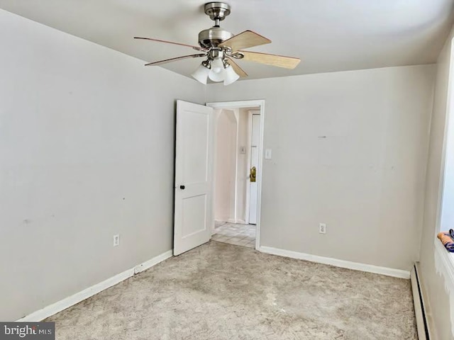 carpeted empty room featuring baseboard heating and ceiling fan