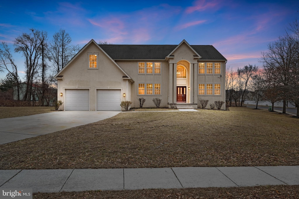 view of front facade with a garage and a lawn