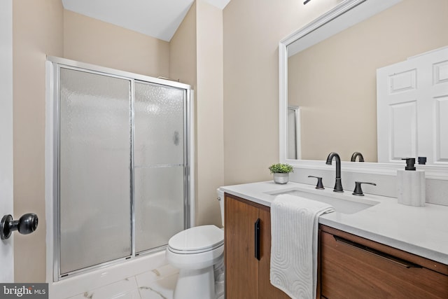 bathroom featuring walk in shower, vanity, and toilet