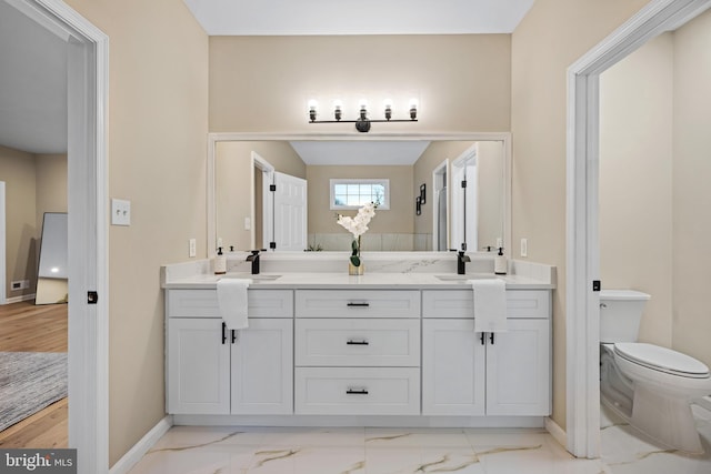 bathroom featuring vanity and toilet