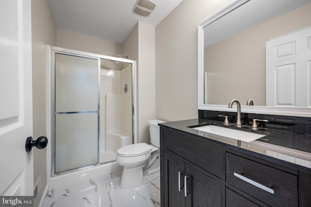 bathroom with walk in shower, vanity, and toilet