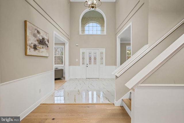 foyer with a high ceiling and an inviting chandelier