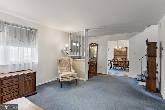 living area with carpet floors and an inviting chandelier