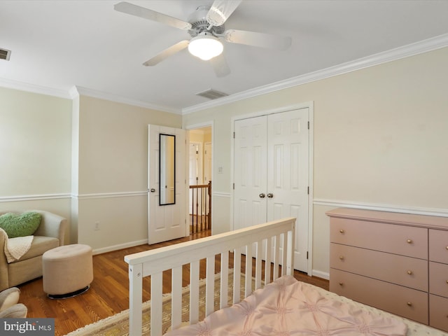 bedroom with hardwood / wood-style flooring, ornamental molding, a closet, and ceiling fan